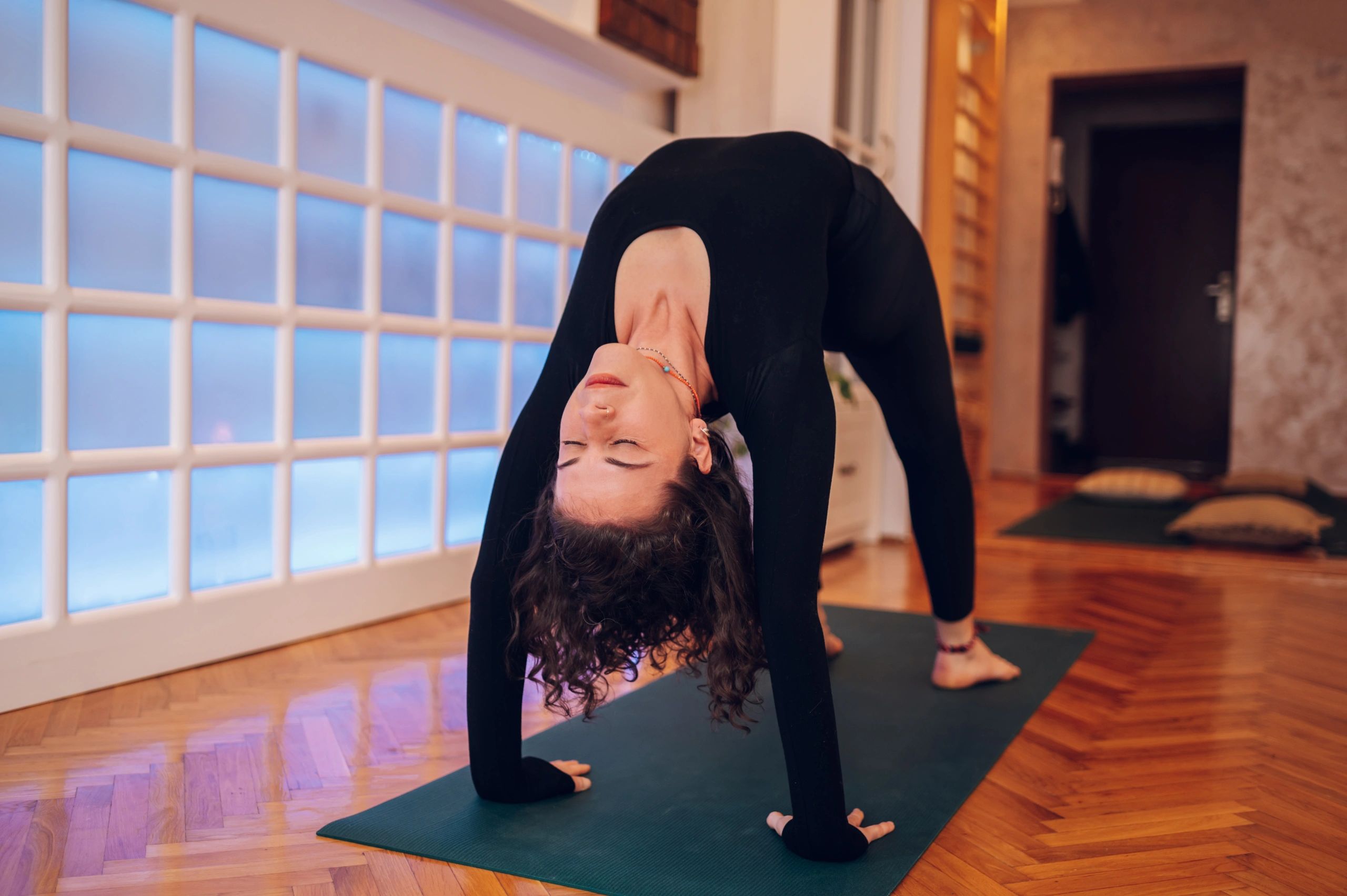 Woman stretching in a calming wellness studio